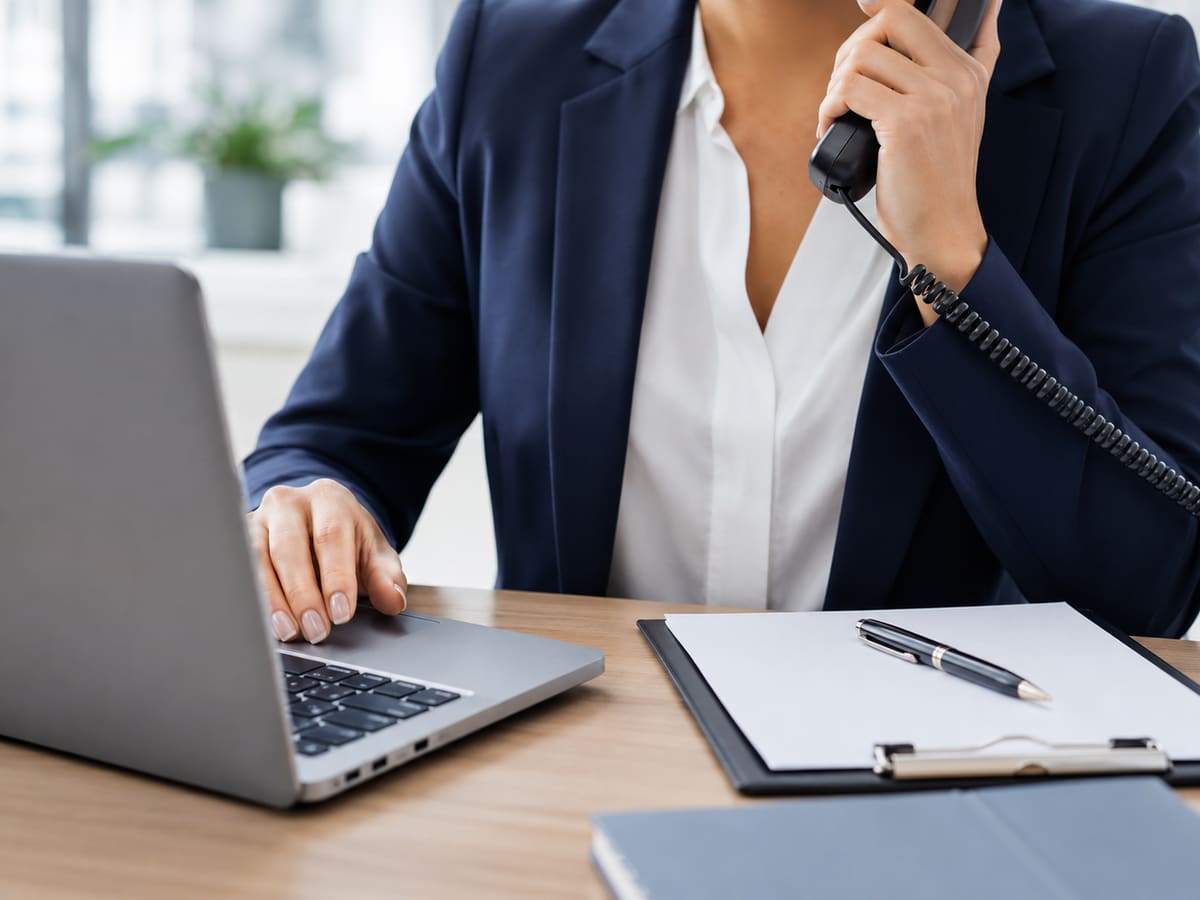 Information Direct team member answering a client phone call at a desk